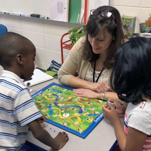 children using board game in speech therapy