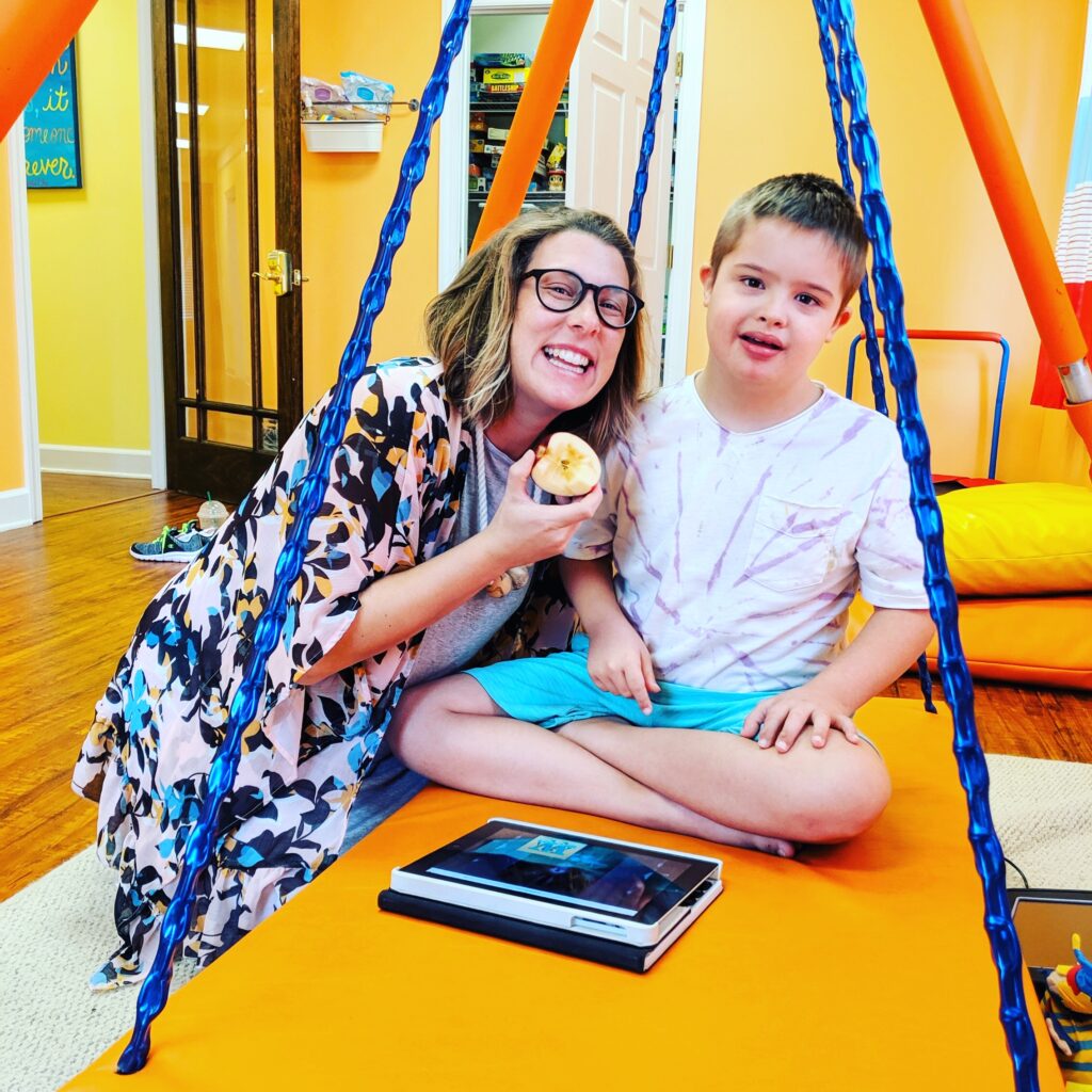 child using occupational therapy swing